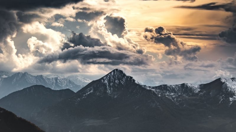 black and white mountains under cloudy sky during daytime